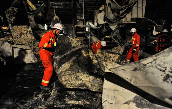 Firefighters search for survivors at the burnt poultry slaughterhouse owned by the Jilin Baoyuanfeng Poultry Company, June 3, 2013.  Poultry plant fire death toll rises to 120