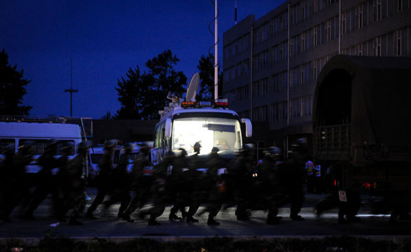 Rescuers are seen at the burnt poultry slaughterhouse owned by the Jilin Baoyuanfeng Poultry Company, June 3, 2013.  Poultry plant fire death toll rises to 120