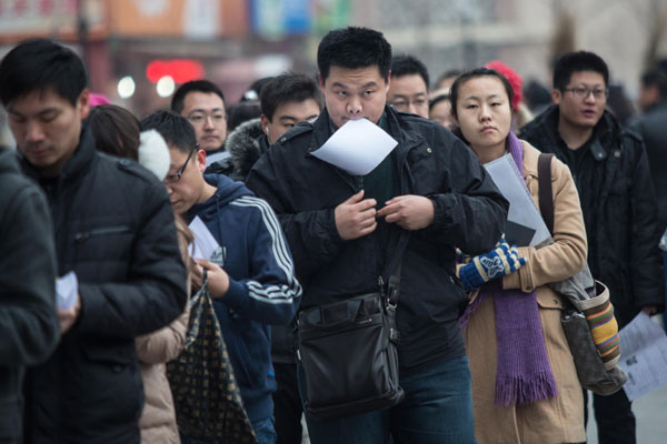 Candidates for the national graduate entrance examination line up for a test at the University of International Business and Economics in Beijing on Saturday. MAO YANZHENG / CHINA DAILY Fewer candidates take graduate entrance test