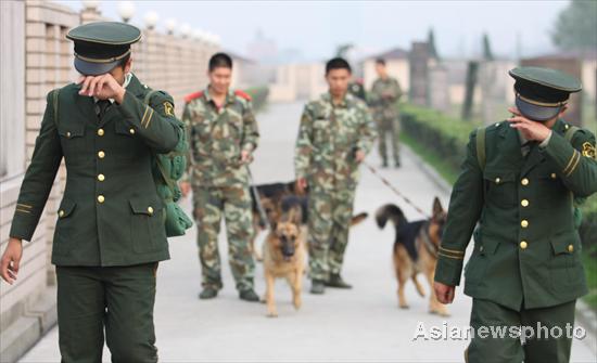 Two retired soldiers wipe tears after bidding farewell to their comrades and police dogs in Hangzhou, eastern Zhejiang province, Nov 23, 2011.  Farewell, my comrades!